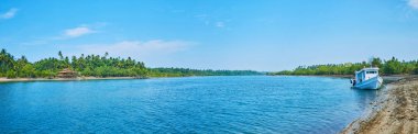 Panorama of Pathein river tributary with lush jungle forests and small fishing villages on the banks, Ngwesaung, Myanmar. clipart