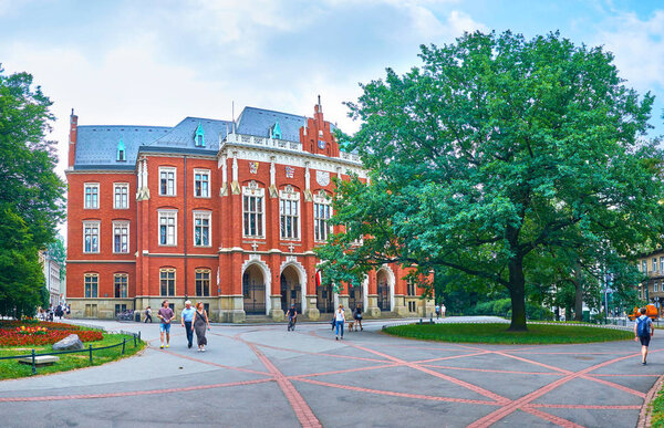 KRAKOW, POLAND - JUNE 11, 2018: The frontage of Collegium Novum, that is the most beautiful and the oldest building of Jagiellonian University, on June 11 in Krakow.