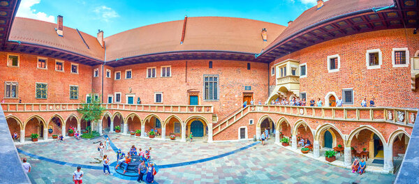 KRAKOW, POLAND - JUNE 11, 2018: Beautiful panorama of courtyard of Collegium Maius with a well in the middle, on June 11 in Krakow.