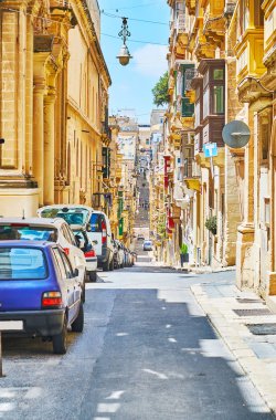 The streets, stretching along the city hills are rich in ascents and descents, lined with old scenic edifices, historical churches and monasteries, Valletta, Malta. clipart