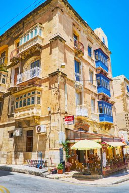VALLETTA, MALTA - JUNE 17, 2018: The small cafe with outdoor terrace at the corner of Lvant and St Dominic streets, on June 17 in Valletta clipart