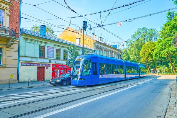 克拉科夫 2018年6月11日 现代风格的电车乘坐沿 Stradomska 街道与历史大厦 在6月11日在克拉科夫 — 图库照片