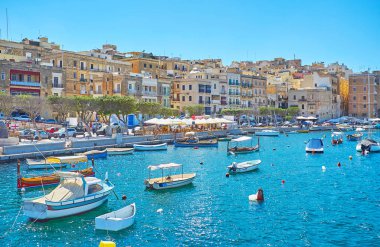 Senglea, Malta - 17 Haziran 2018: Balıkçı tekneleri, geleneksel luzzu ve dghajsa su taksi, kıyı, L-Isla (Senglea) ile açık hava kafeleri ve barları, 17 Haziran'da Senglea içinde filo.