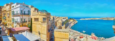 VALLETTA, MALTA - JUNE 17, 2018: The upper tier of St Peter and Paul Bastion is perfect viewpoint, overlooking old town and Grand Harbour, on June 17 in Valletta clipart