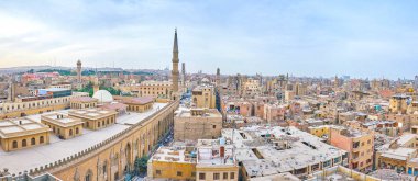 Panorama of Islamic Cairo with ramshackle houses, tall minarets and huge Al-Hussein Mosque on the foreground, Egypt clipart