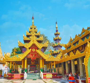YANGON, MYANMAR - FEBRUARY 27, 2018: Richly decorated pavilion of  Tharrawaddy Min Bell (Maha Tissada Gandha Bell) in Shwedagon Pagoda complex, on February 27 in Yangon. clipart