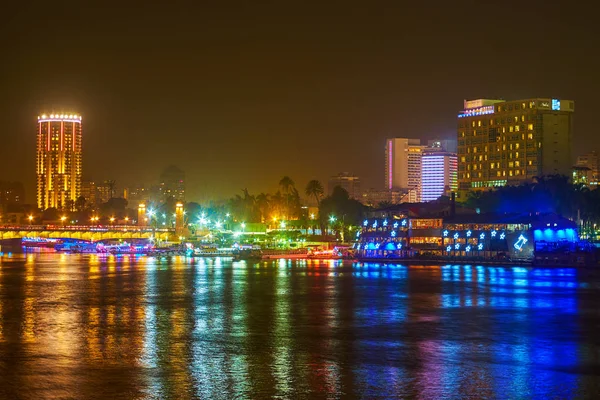 杰济拉岛的照明高楼反映在埃及开罗尼罗河的黑暗水域中 — 图库照片