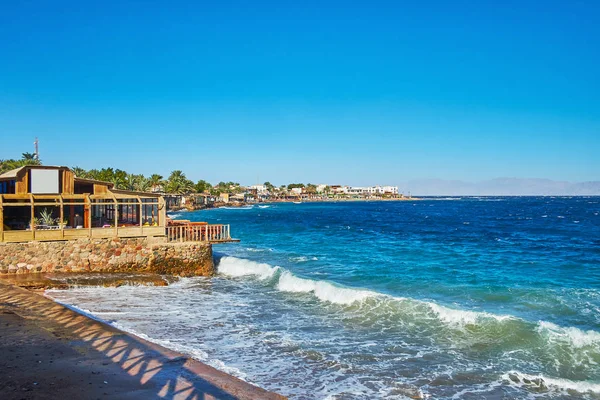 Fırtına dalgaları sahil Dahab Resort, görünüm üzerinde rocky Dağları, Suudi Arabistan, Akabe Körfezi'nde yer alan taşırken, Sinai, Mısır.