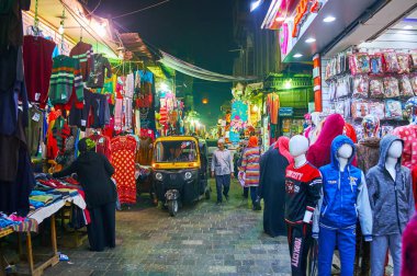 Cairo, Mısır - 21 Aralık 2017: Meşgul Dar Al Muizz sokak giysi ile insanlar yürüyen ve 21 Aralık Kahire'de tuk tuks, sürüş tezgahları.