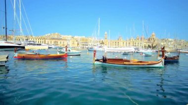 Senglea, Malta - 19 Haziran 2018: doğal luzzu yumuşak dalgalar Vittoriosa Marina manzaralı bir ortaçağ Birgu ve onun tersaneler arka plan, Yatlar ile 19 Haziran Senglea tarihinde sallanan deniz araçları,.