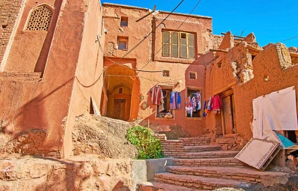 The small garment shop with wide range of traditional local attire in old adobe house of Abyaneh village, Iran.