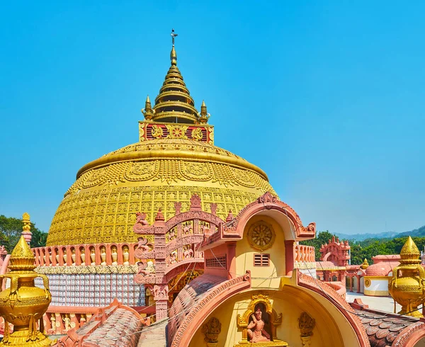 Watch the picturesque pagoda of Sitagu International Buddhist Academy from its tower, overlooking the site and its complex details, such as hti umbrella, torana gate, carved walls and multiple statues, Sagaing, Myanmar.