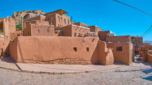 Panorama of Abyaneh village with reddish adobe houses on the slope of Karkas mountains, Iran.