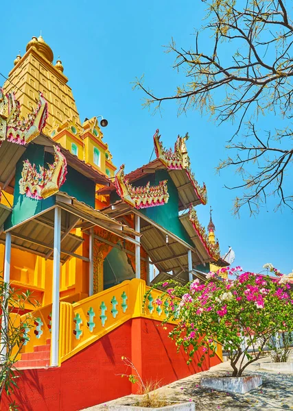 The rich decoration of the Image House of U Min Thonze Caves with beautiful pyatthat roof and golden tower in the middle, Sagaing, Myanmar.