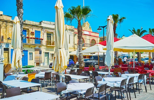 Rahat açık hava kafeleri Marsaxlokk shore Marina sunar lezzetli balık yemekler ve serinletici içecekler, Malta.