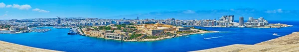 The walls of Valletta fortress open the view on the stunning Manoel Island and the coast of Ta\'Xbiex, Gzira and Sliema cities behind it, Malta.