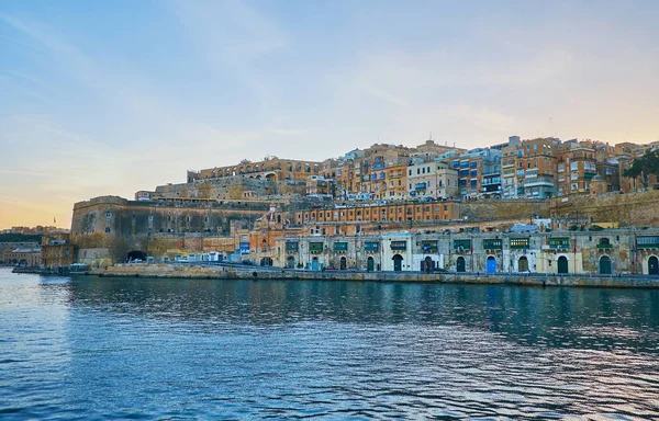Enjoy romantic sunset cruise around Valletta with a view on historic edifices, historic Quarry Wharf and preserved Fort Lascaris (battery, bastion), Malta.