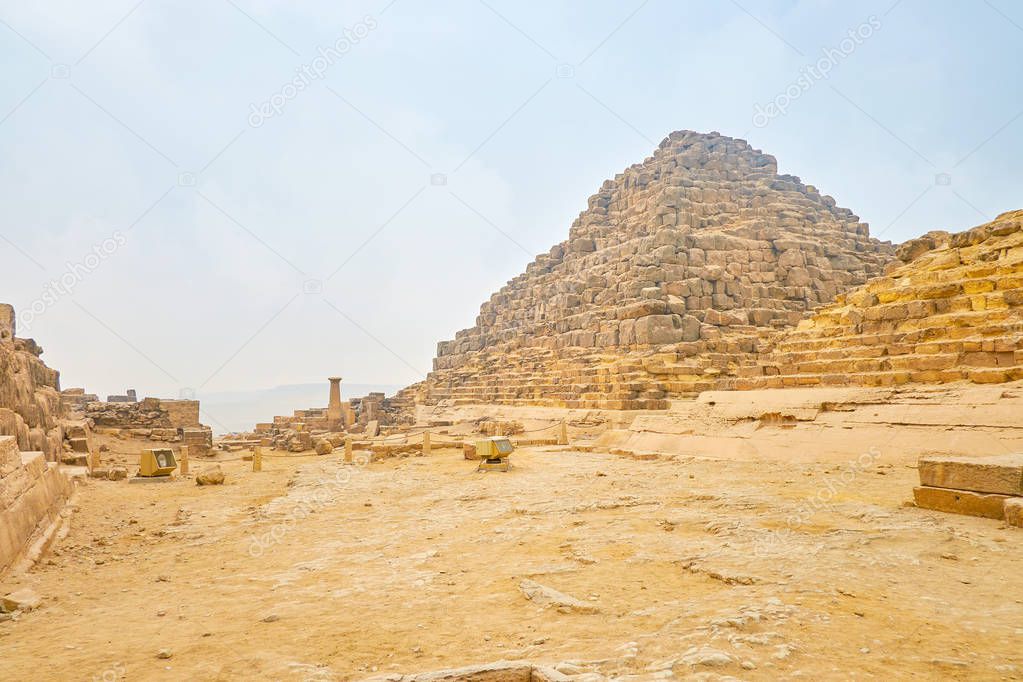 The ruins of small pyramids of the Queens in the arhceoligical site next to the Great Pyramid of Giza, Egypt