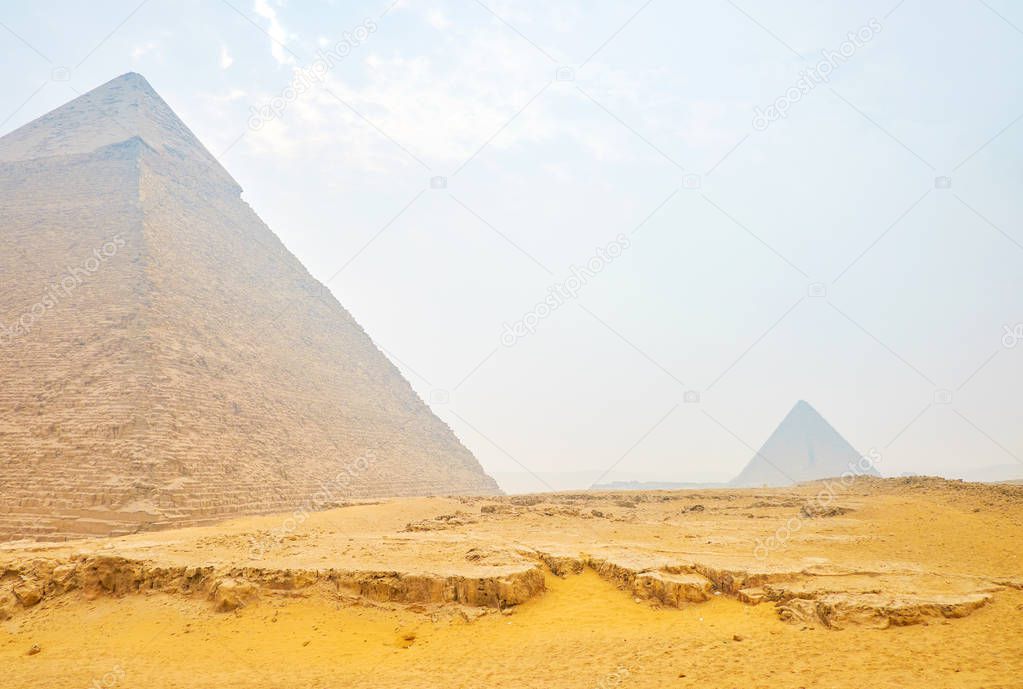 The Giza pyramid complex located in the midst of the sand dunes and often are shrouded with dust, Egypt