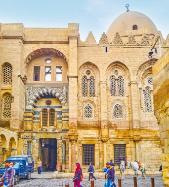 CAIRO, EGYPT - DECEMBER 20, 2017: Qalawun complex with beautiful arabic carvings and patterns located in the heart of Cairo and always secured and patrolled by mounted police, on December 20 in Cairo. clipart