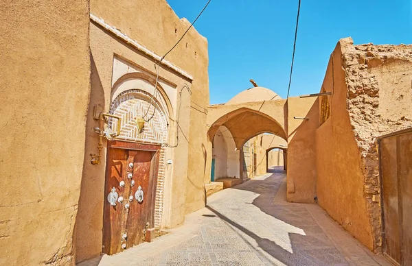 Get lost in medieval adobe quarters of Yazd with narrow winding streets, multitude of deadlocks, shady passageways (kuche) and tall clay blank walls , Iran.