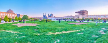 ISFAHAN, IRAN - OCTOBER 19, 2017: Panorama of the large grass area in Nashq-e Jahad Sqaure, a popular place for active games, on October 19 in Isfahan