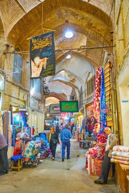 ISFAHAN, IRAN - OCTOBER 21, 2017: Get lost in maze of narrw brick alleyways of historic Grand (Soltani) Bazaar with many interesting stalls, workshops and architectural landmarks, on October 21 in Isfahan. clipart