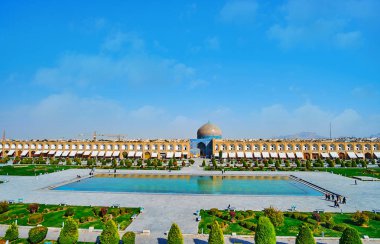 The view on ornamental garden, fountain and historic Sheikh Lotfollah mosque in Naqsh-e Jahan square from the summer terrace of Ali Qapu palace, Isfahan, Iran. clipart
