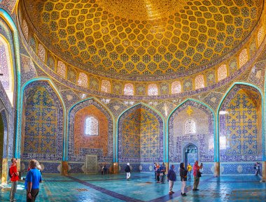 ISFAHAN, IRAN - OCTOBER 21, 2017: The prayer hall of Sheikh Lotfollah mosque with fine tile decorations, arched walls and large dome, on October 21 in Isfahan. clipart
