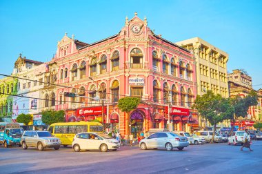 YANGON, MYANMAR - FEBRUARY 15, 2018: The busy Downtown street with preserved British Colonial style mansions, nowadays serving as business offices, stores or art galleries, on February 15 in Yangon.