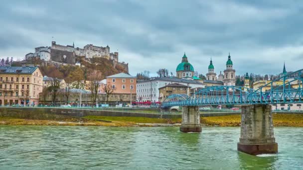 SALZBURG, AUSTRIA - MARCH 1, 2019: Enjoy historic cityscape with a view on Hohensalzburg Fortress, Cathedrals dome and bell towers, Mozartsteg bridge and Salzach river, on March 1 in Salzburg