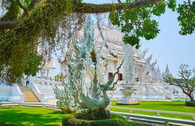 The statue of Nok Hatsadiling in garden of White Temple, Chiang  clipart
