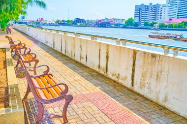 The line of benches on the promenade of Chao Phraya river, Bangk clipart