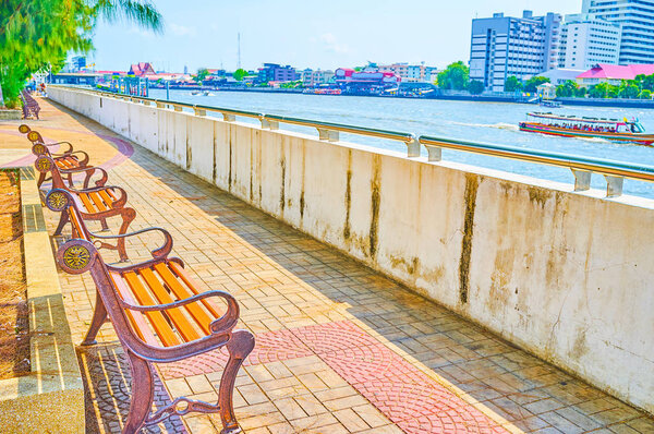The line of benches on the promenade of Chao Phraya river, Bangk