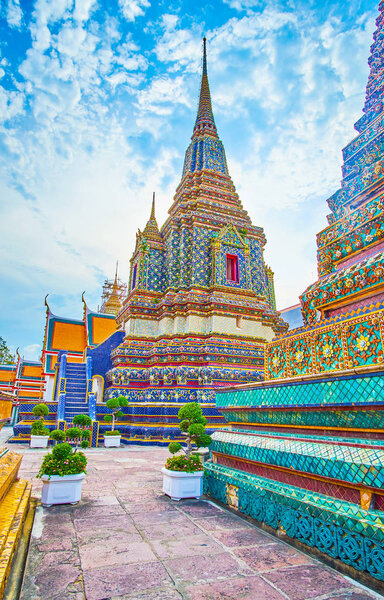 Walking between beautiful stupas in Wat Pho complex, Bangkok, Th