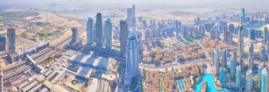 DUBAI, UAE - MARCH 3, 2020: The magnificent view from the top of Burj Khalifa building on the modern Downtown district with largest Dubai Mall and surrounding skyscrapers, on March 3 in Dubai clipart