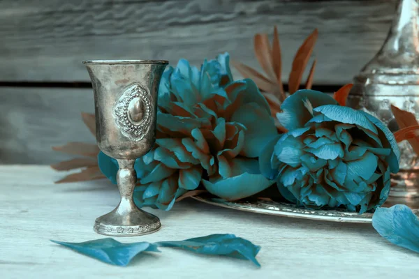 Metal vessel and blue peonies — Stock Photo, Image