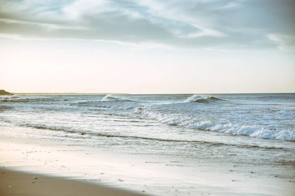 Beach photography - blue ocean waves, sand, overcast sky