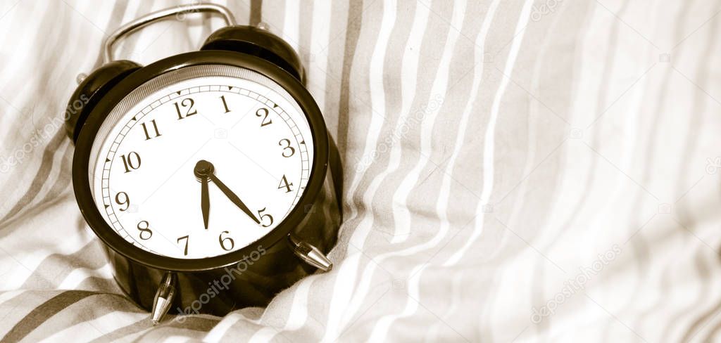 Alarm clock - vintage  classic alarm clock next to bed in bedroo
