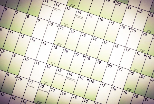 Wall calendar with days and dates isolated from blurred backgrou