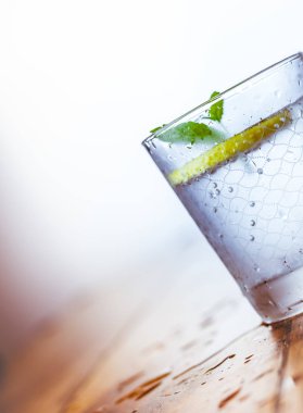 Bir cam kabı ve bir beyaz tahta geri soğuk limonata sürahi