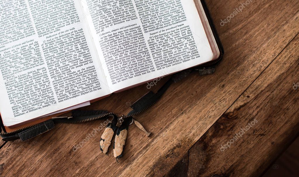Holy Bible isolated on old vintage wooden table