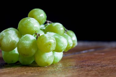 Bağbozumu masasında taze organik üzümler.