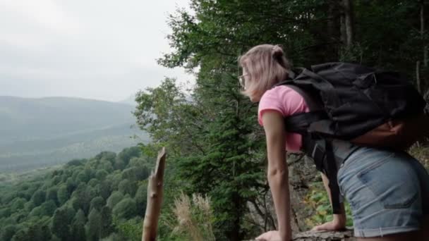 A menina olha para a floresta do penhasco — Vídeo de Stock