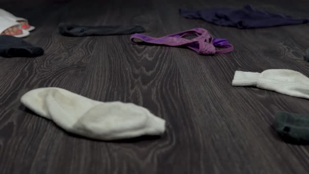 Cleaning up the scattered dirty things in the room. Cleaning things special manual tongs. Socks and underpants are lying on the floor. — Stock Video