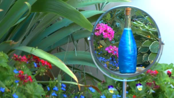 Blue elixir in the bottle is reflected in the mirror — Stock Video