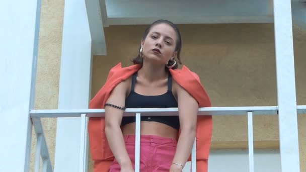 Glamor girl posing on a balcony. The girl is stylishly dressed — Stock Video