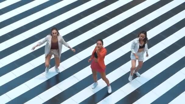 Glamor girls dancing on a striped background top view. Girl dressed in stylish clothes — Stock Video