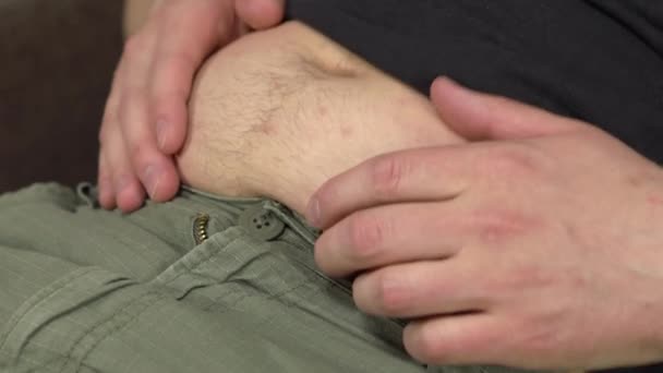 A young man touches his fat belly. Gained excess weight in quarantine. Belly close up. — Stock Video