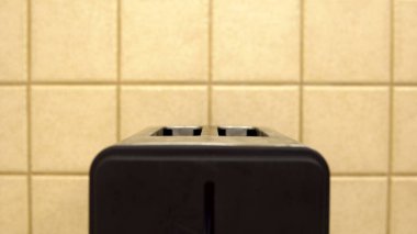 Kahvaltıda kızarmış ekmek yapmak için tost makinesi. Mutfakta elektrikli alet var.